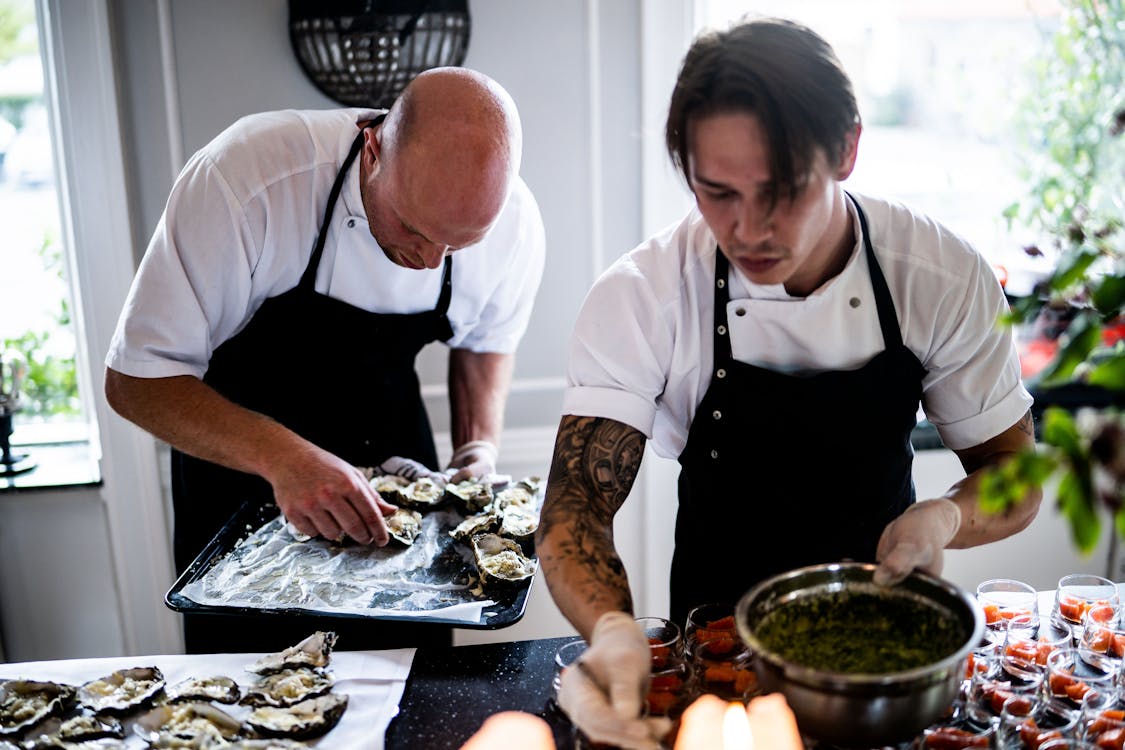 Chef plating a dish in a professional kitchen during a culinary internship abroad
